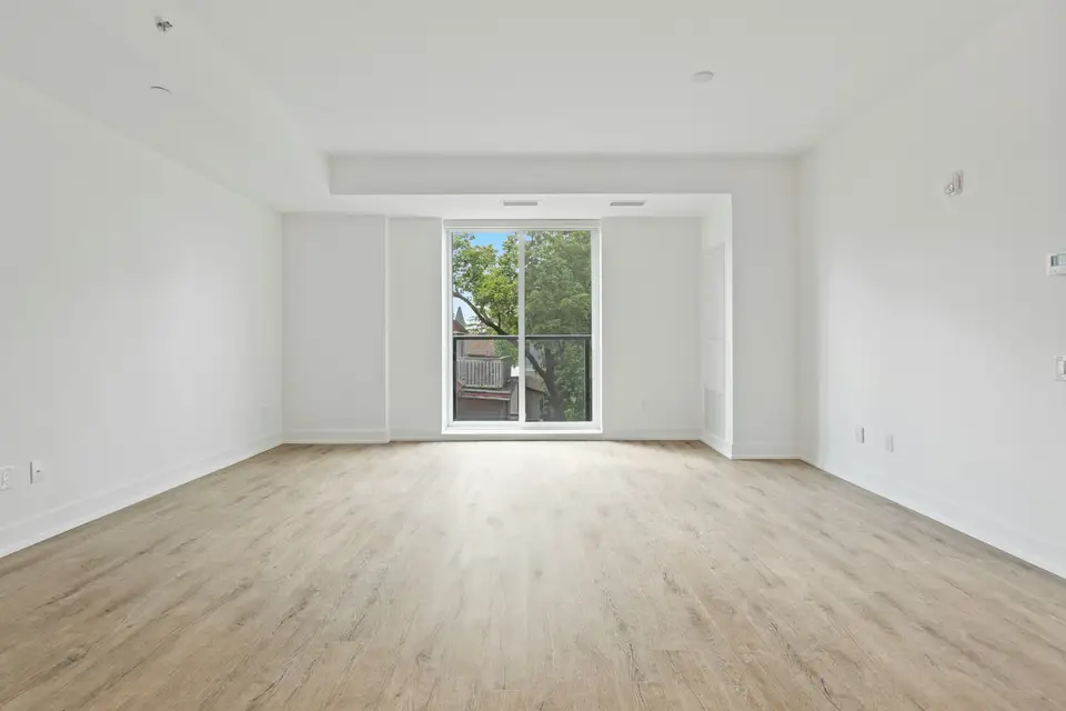 Cleaner using a HEPA vacuum on a window sill in a newly renovated room